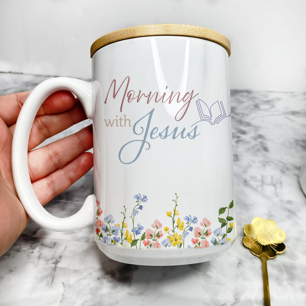 Personalized Christian coffee mug for women featuring a minimalist wildflower design and the text "Mornings with Jesus", shown as an elegant 15oz mug set with a bamboo lid and gold spoon on a clean background.