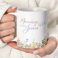 Personalized Christian coffee mug for women featuring a minimalist wildflower design and the text "Mornings with Jesus", shown as an elegant 15oz mug set with a bamboo lid and gold spoon on a clean background.
