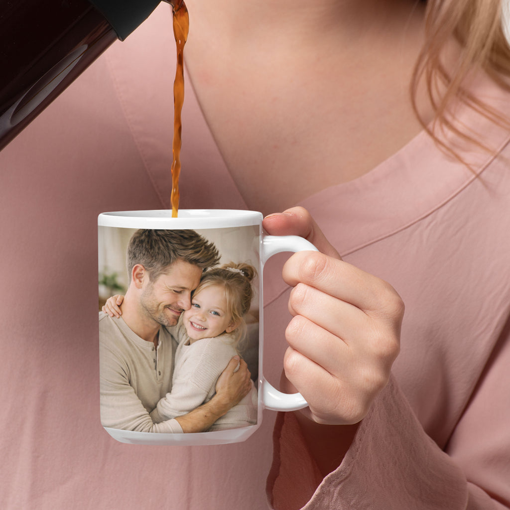 Example design of a 15 oz personalized photo mug showing a father and child, with coffee being poured into the mug, demonstrating how a customer photo can look when printed.