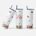 Three white tumblers with floral and butterfly designs on a white background